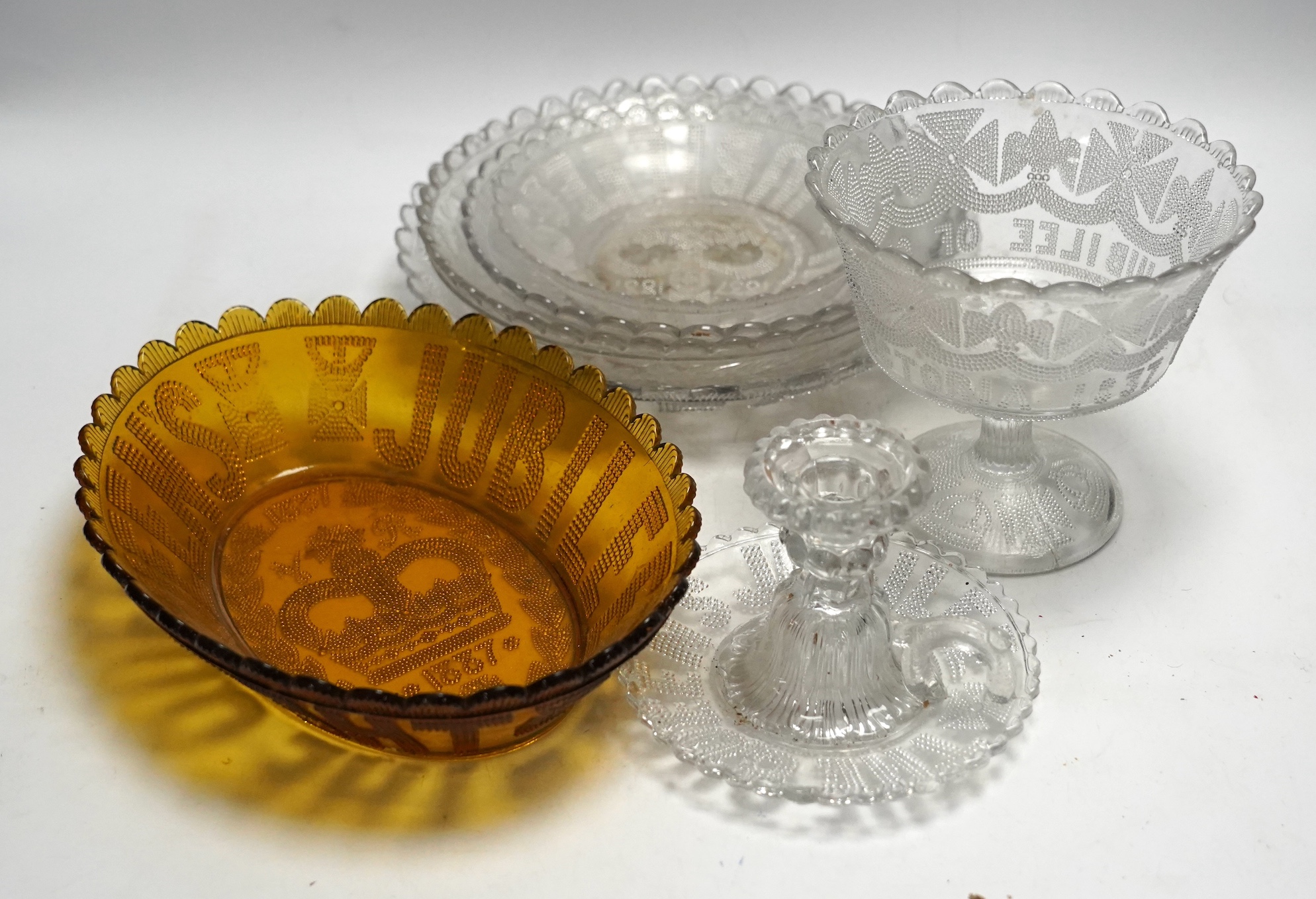 Seven press moulded glass commemorative items celebrating Queen Victoria's Diamond Jubilee. Condition - fair